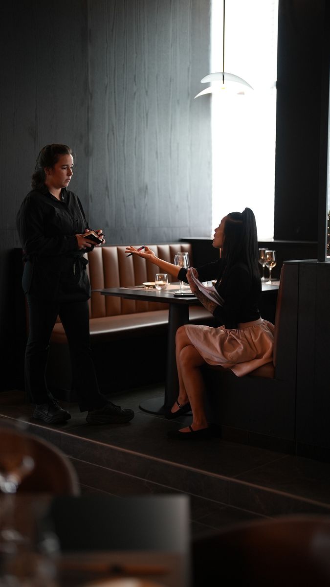 Guests in a leather booth under warm light