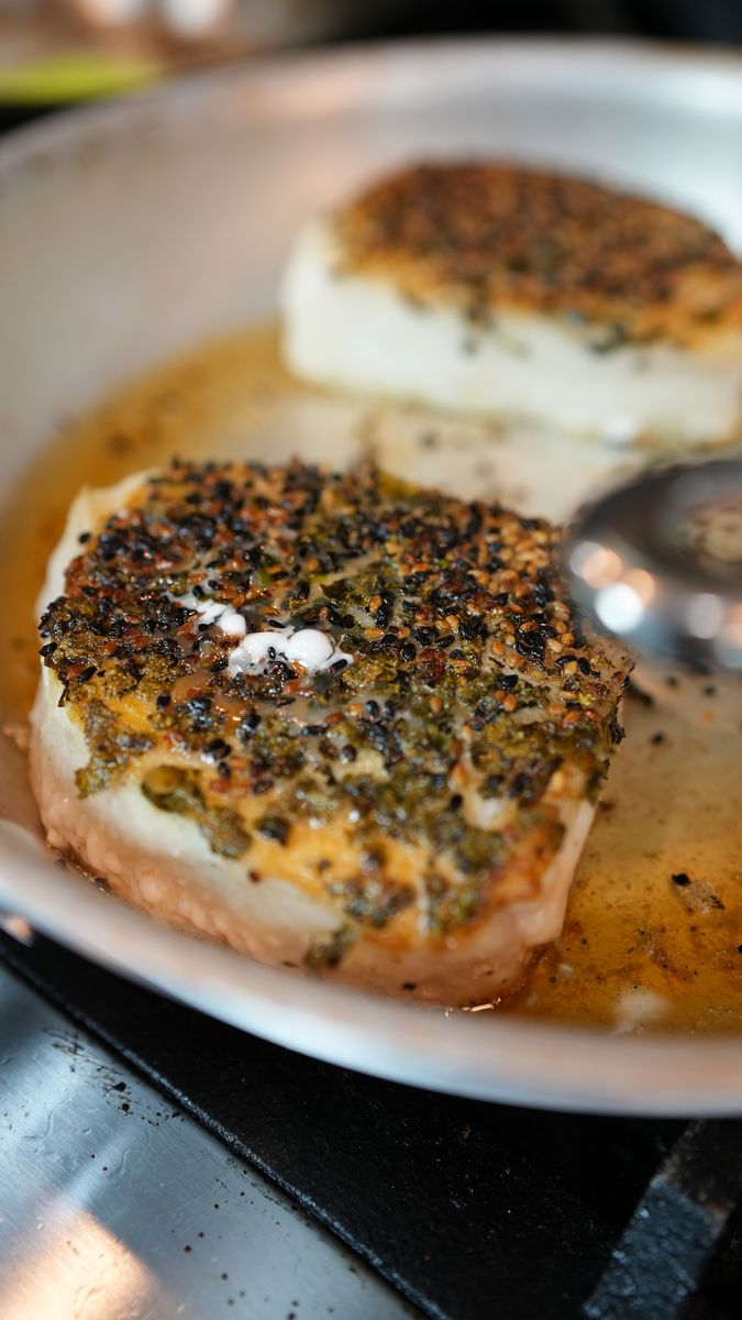 Seed-crusted pieces basting in a hot pan