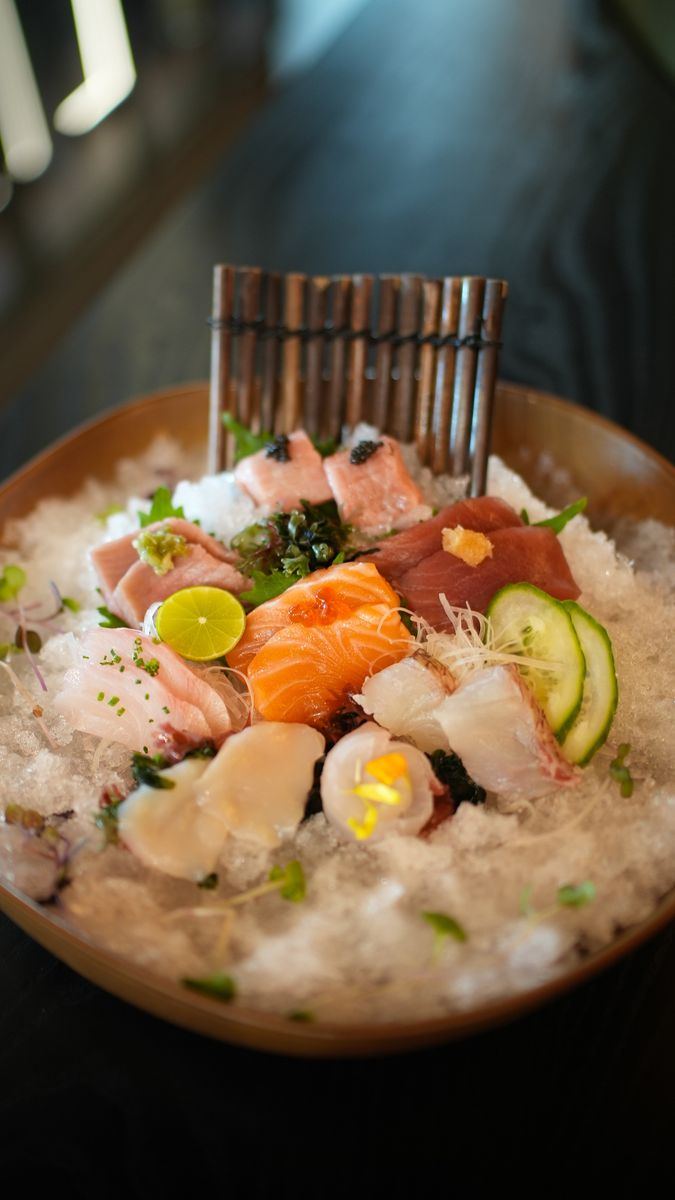 A sashimi platter on ice with salmon, tuna and shrimp